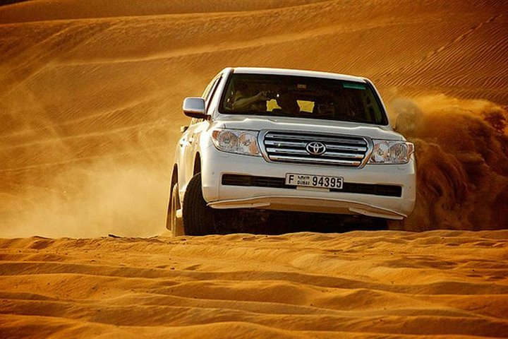 Experience the Dubai desert in a private 4x4 vehicle engaging in sandboarding and dune bashing while enjoying breathtaking views of the golden sands and stunning landscapes.